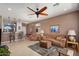Open living room with a cozy seating area and breakfast bar at 21613 N 261St Ave, Buckeye, AZ 85396