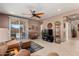 Spacious living room featuring a ceiling fan and patio access at 21613 N 261St Ave, Buckeye, AZ 85396