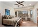Bright main bedroom with bay windows and a ceiling fan at 21613 N 261St Ave, Buckeye, AZ 85396