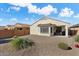 Backyard view of house with gravel and a covered patio at 21613 N 261St Ave, Buckeye, AZ 85396
