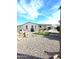 Spacious backyard with covered patio, artificial turf, and grill at 2400 E Baseline Ave # 73, Apache Junction, AZ 85119