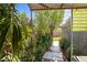 Landscaped backyard with a tiled pathway and mature plants at 3901 W Solano N Dr, Phoenix, AZ 85019