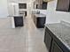 Modern kitchen with granite countertops and dark cabinets at 18399 W Tina Ln, Surprise, AZ 85387