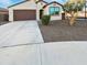 Single story house with brown garage door and landscaping at 18399 W Tina Ln, Surprise, AZ 85387