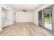 Living room with vinyl flooring and sliding glass door to backyard at 10263 W Snead S Cir, Sun City, AZ 85351