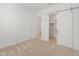 Spacious bedroom with neutral carpet and large closet with barn door at 24741 N 175Th Dr, Surprise, AZ 85387