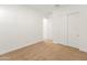 Bright bedroom with neutral walls, carpet, and double door closet at 24741 N 175Th Dr, Surprise, AZ 85387