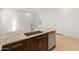 Modern kitchen island with granite countertop and stainless steel sink at 24741 N 175Th Dr, Surprise, AZ 85387