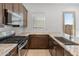 L-shaped kitchen with granite countertops and modern cabinetry at 24741 N 175Th Dr, Surprise, AZ 85387