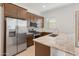 Spacious kitchen featuring wood cabinets and stainless steel appliances at 24741 N 175Th Dr, Surprise, AZ 85387