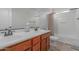 Bathroom boasts double sinks, a tub shower, and wood cabinets at 955 S Henry Ln, Gilbert, AZ 85296