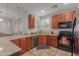 Modern kitchen with wood cabinets, stainless steel appliances, and granite countertops at 955 S Henry Ln, Gilbert, AZ 85296