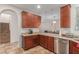 Kitchen with wood cabinets, granite countertops and stainless steel dishwasher at 955 S Henry Ln, Gilbert, AZ 85296