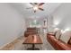 Bright living room with leather sofas, a coffee table, and access to the dining area at 955 S Henry Ln, Gilbert, AZ 85296