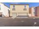 Two-car garage with tan doors and two additional windows at 955 S Henry Ln, Gilbert, AZ 85296