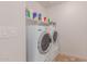 Convenient laundry room with washer, dryer, and shelving at 955 S Henry Ln, Gilbert, AZ 85296