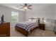 Cozy bedroom with wood bed frame and ceiling fan at 955 S Henry Ln, Gilbert, AZ 85296