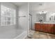 Clean bathroom with soaking tub, shower, and wood cabinets at 955 S Henry Ln, Gilbert, AZ 85296