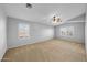 Spacious bedroom with ceiling fan and neutral carpeting at 16800 W Mesquite Dr, Goodyear, AZ 85338