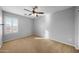 Bright bedroom with window and ceiling fan at 16800 W Mesquite Dr, Goodyear, AZ 85338
