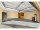 Spacious garage with built-in cabinets and refrigerator at 16800 W Mesquite Dr, Goodyear, AZ 85338
