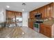 Kitchen boasts granite countertops, stainless steel appliances, and wood cabinetry at 16800 W Mesquite Dr, Goodyear, AZ 85338