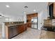 Modern kitchen with granite countertops, stainless steel appliances, and wood cabinets at 16800 W Mesquite Dr, Goodyear, AZ 85338