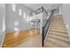 Two-story living room with hardwood floors, high ceilings, and a loft area at 16800 W Mesquite Dr, Goodyear, AZ 85338