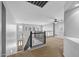 Spacious loft area with neutral carpeting and a ceiling fan at 16800 W Mesquite Dr, Goodyear, AZ 85338