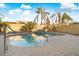 Refreshing kidney-shaped pool surrounded by palm trees at 16800 W Mesquite Dr, Goodyear, AZ 85338
