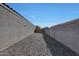 Gravel backyard with block wall and gate at 4354 E Italian Trotter Rd, San Tan Valley, AZ 85140