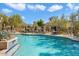 Community pool with lounge chairs and umbrellas at 16420 N Thompson Peak Pkwy # 1009, Scottsdale, AZ 85260