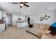 Bright living room with beige sectional sofa and ceiling fan at 22344 W Hopi St, Buckeye, AZ 85326