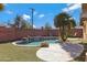 Relaxing kidney-shaped pool surrounded by a spacious patio and desert landscaping at 1859 N Morris --, Mesa, AZ 85201