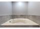 Round bathtub with grey tile surround at 1859 N Morris --, Mesa, AZ 85201