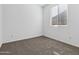 Simple bedroom with carpeted floor and a window at 1241 E Gabrilla Dr, Casa Grande, AZ 85122