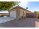 Rear view of a one-story house with a two-car garage at 41547 W Cheyenne Ct, Maricopa, AZ 85138