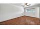 Well-lit bedroom featuring wood flooring at 2327 E Betty Elyse Ln, Phoenix, AZ 85022