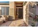 Front entry with stone walkway and modern dark door at 10646 E Butherus Dr, Scottsdale, AZ 85255