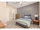 Bedroom with striped bedding and a dresser at 1960 E Blackhawk Dr, Gilbert, AZ 85298