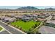 Community overview showcasing homes with mountain views and a large green space at 1960 E Blackhawk Dr, Gilbert, AZ 85298