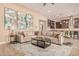 Bright living room with large sectional sofa and a view into the kitchen area at 1960 E Blackhawk Dr, Gilbert, AZ 85298