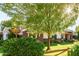 Landscaped front yard with brick home and wooden pergola at 2677 E Queen Creek Rd, Gilbert, AZ 85297