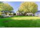 Expansive backyard featuring a pergola and lush lawn at 2677 E Queen Creek Rd, Gilbert, AZ 85297