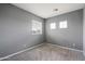 Small bedroom with gray walls and carpet at 10468 W Palm Ln, Avondale, AZ 85392