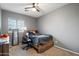 Bedroom with a queen bed and a home office setup at 10468 W Palm Ln, Avondale, AZ 85392