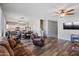 Open living room featuring hardwood floors, a fireplace, and ample natural light at 10468 W Palm Ln, Avondale, AZ 85392