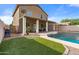 Home features a sparkling pool, covered patio, and grassy backyard at 10468 W Palm Ln, Avondale, AZ 85392
