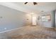 Bright living room with neutral walls and ceiling fan at 10468 W Palm Ln, Avondale, AZ 85392