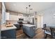 Modern kitchen with an island, stainless steel appliances, and white shaker cabinets at 10468 W Palm Ln, Avondale, AZ 85392